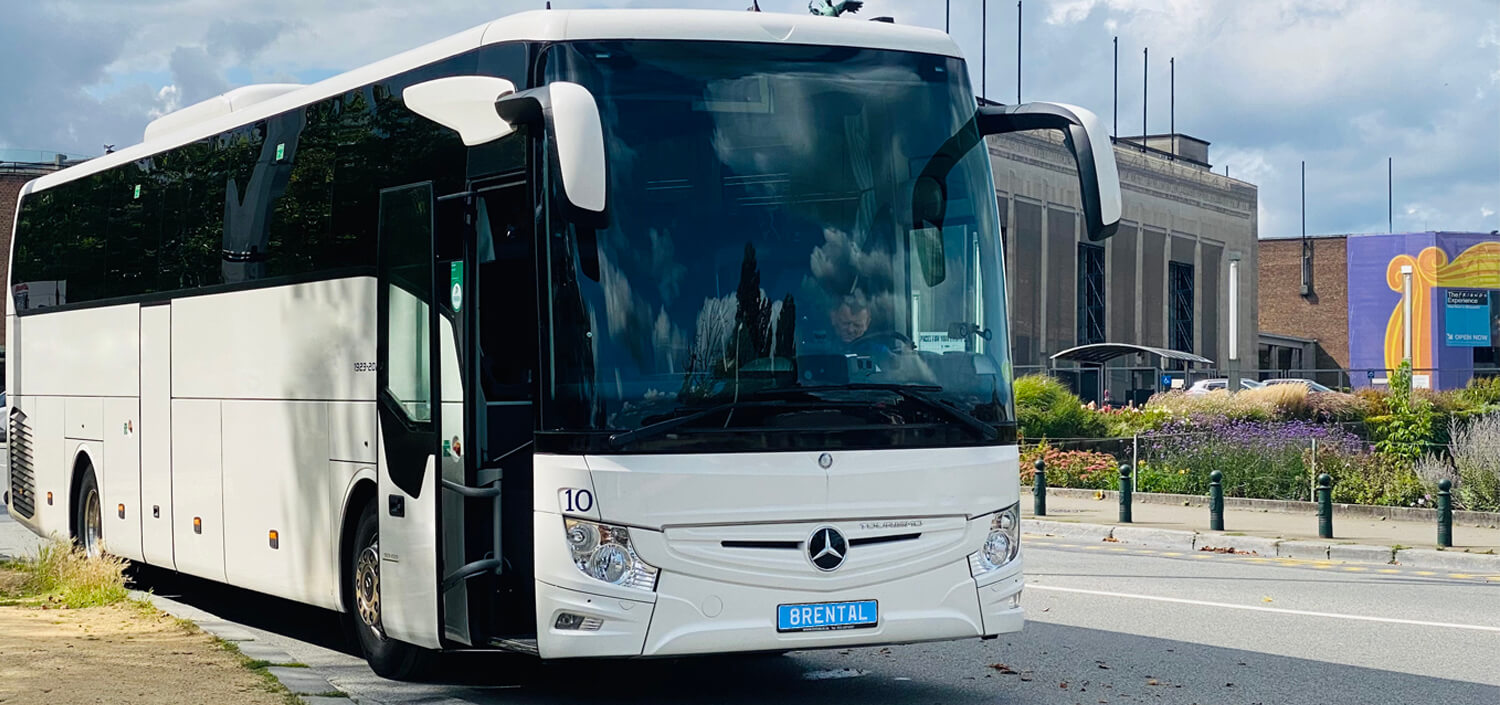 real 8rental coach with driver waiting for travelers