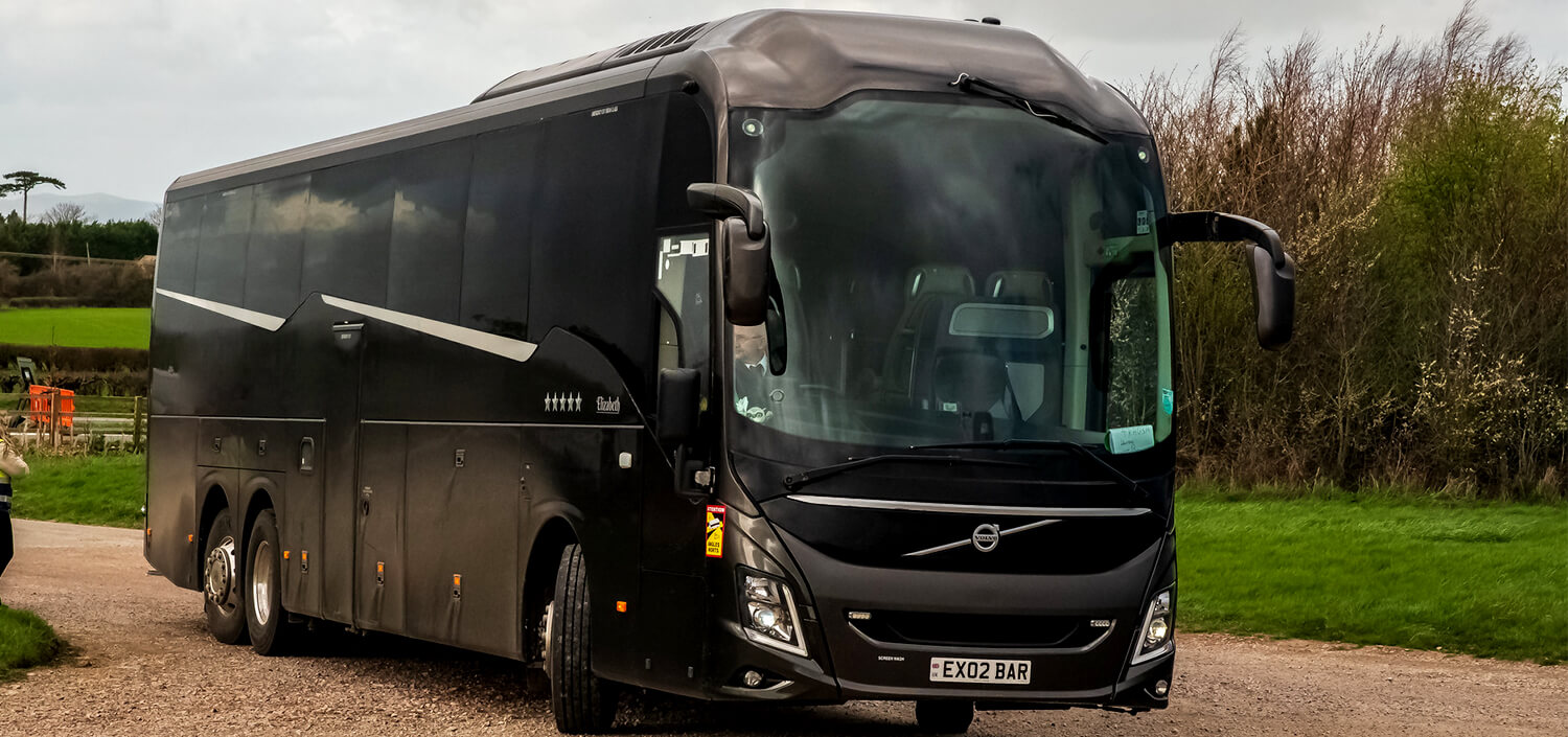 Coach with driver with travellers on road