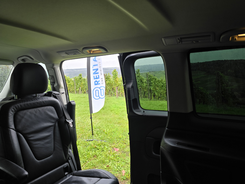 inside 8rental minibus with flag outside