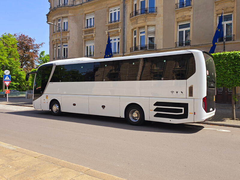 real coach waiting for group near hotel